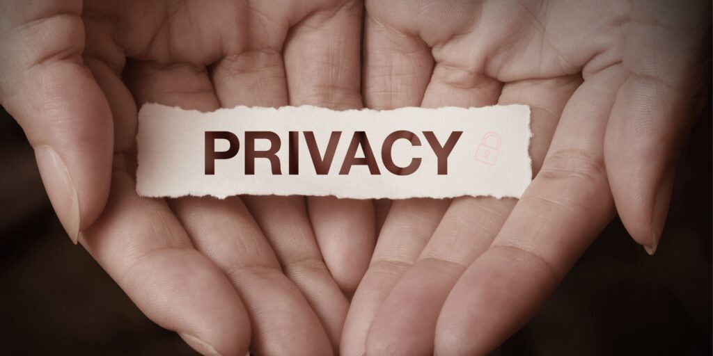 “Two hands holding a piece of paper with the word ‘Privacy’—symbolizing care and protection in counselling services